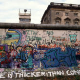 Graffitti on the Berlin Wall by the east german watchtower.